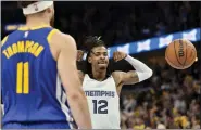  ?? BRANDON DILL - THE ASSOCIATED PRESS ?? Memphis Grizzlies guard Ja Morant (12) reacts after scoring as Golden State Warriors guard Klay Thompson (11) looks on during Game 1 of a second-round NBA basketball playoff series Sunday, May 1, 2022, in Memphis, Tenn.