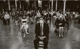  ?? Photos by Evan Vucci / Associated Press ?? Arizona Gov. Doug Ducey, front, and others wait to hear President Donald Trump speak after a tour of a Honeywell plant in Phoenix that makes masks.