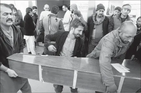  ?? Jawad Jalali EPA/Shuttersto­ck ?? THE BODY of one of at least 41 killed in the bombing is moved at a hospital in Kabul, Afghanista­n. Dozens more were reported wounded.