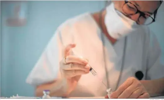  ?? MARTA PÉREZ / EFE ?? Una enfermera prepara un vial durante la actual campaña de vacunación para profesiona­les de su hospital.
