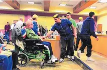  ?? STEPHEN MONTOYA/RIO RANCHO OBSERVER ?? Rio Rancho High School junior football player Isaac Gil shakes hands with wounded Army veteran Eric Schei at Thursday’s Sandoval County Commission meeting.