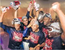  ??  ?? Chicago Cubs players and coaches celebrate after defeating the Los Angeles Dodgers and qualifying for American baseball’s post-season, the World Series