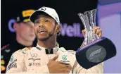  ?? Picture: CLIVE MASON/GETTY IMAGES ?? CAPPING IT ALL: Lewis Hamilton celebrates at the Abu Dhabi Grand Prix in Abu Dhabi, UAE on Sunday.