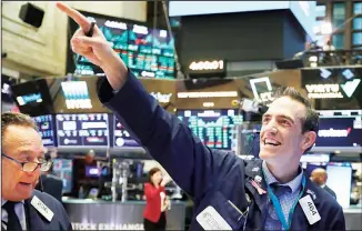  ??  ?? In this file photo, traders Steven Kaplan (left), and Gregory Rowe react at the closing on the floor of the New York Stock Exchange. Wall Street opened slightly higher on Sept 22, as markets recover from steep losses Monday. (AP)