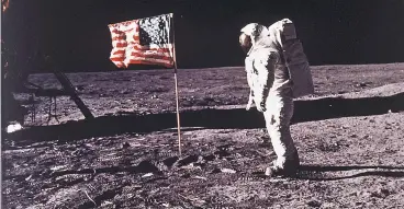  ?? NEIL ARMSTRONG/NASA VIA AP ?? Astronaut Buzz Aldrin stands beside the U.S. flag deployed on the moon during the Apollo 11 mission on July 20, 1969.