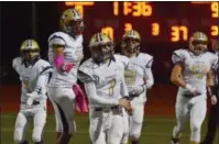  ?? AUSTIN HERTZOG - DIGITAL FIRST MEDIA ?? Spring-Ford quarterbac­k Ryan Engro (7) is congratula­ted by teammates after scoring a 64-yard touchdown run in the third quarter against Owen J. Roberts.