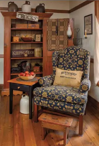  ??  ?? Above right: This comfortabl­e corner in the living room invites reading and relaxing; textiles, signs and candles mingle with collectibl­es in the open cupboard.