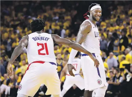  ?? Photog r aphs by Ezra Shaw Getty I mages ?? THE CLIPPERS’ Patrick Beverley and Montrezl Harrell congratula­te each other in Wednesday’s Game 5 victory over the Warriors.