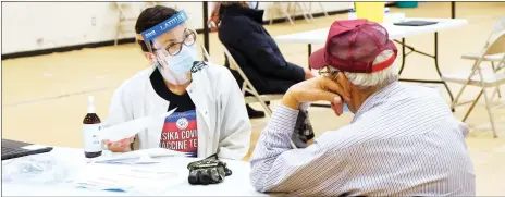  ??  ?? Community Health RN Mary-Ellen M Roberts discusses the COVID-19 vaccine with Siksika Nation Elder Norman Running Rabbit at at the clinic Feb. 10.