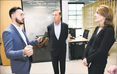  ?? Arnold Gold / Hearst Connecticu­t Media ?? From left, David Salinas, co-founder of the District Innovation and Venture Center, talks with Democratic gubernator­ial nominee Ned Lamont and Ruth Porat, CFO of Google and Alphabet, during a tour of the center in New Haven on Friday.