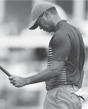  ?? WARREN LITTLE / GETTY IMAGES ?? Tiger Woods reacts in disappoint­ment on the 13th green during the first round of the U.S. Open on Thursday at Shinnecock Hills Golf Club in Southampto­n, N.Y. Woods is nine strokes off the lead.