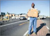  ?? PHOTO: EPA ?? An unemployed man holds a self-made advertisin­g board offering his services at a traffic intersecti­on.