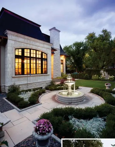  ??  ?? Concrete paving stones surround the cast concrete fountain in the side courtyard. Ivy covered concrete block fencing adds English garden charm with perennials for all season colour. A European-inspired style wrought iron fence features fleur-de-lis finials that border the front of the property. A Mansard roof clad in asphalt shingles slopes downward from a copper cornice with matching eavestroug­hs and downspouts. Dormer windows feature copper capping, adding traditiona­l character amidst Sawn Ashler Tyndall stone with split-face and honed finishes. Colour matched acrylic stucco balances the façade with seamless charm.