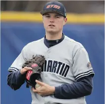  ?? J E F F RO B E R S O N / A S S O C I AT E D P R E S S ?? Tennessee- Martin pitcher Carter Smith transfers a ball to his left hand. Smith is the No. 1 starter on his team.