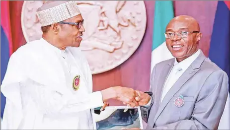  ?? STATE HOUSE ?? President Muhammadu Buhari (left), being presented with an iPAD by the President/Chairman-In-Council, Prof Charles Uwadia, during a courtesy call by the Computing and Informatio­n Technology Profession­als and Community of Nigeria, Computer Profession­als Registrati­on Council of Nigeria and Nigeria Computer Society at the State House, Abuja