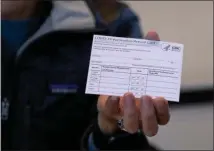 ?? ASSOCIATED PRESS ?? In this Jan. 10, 2021 file photo, Sarah Gonzalez of New York, a Nurse Practition­er, displays a COVID-19 vaccine card at a New York Health and Hospitals vaccine clinic in the Brooklyn borough of New York.