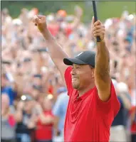  ??  ?? Tiger Woods celebrates as he wins the Tour Championsh­ip on the 18th green during the final round on Sunday at East Lake Golf Club in Atlanta, Ga.