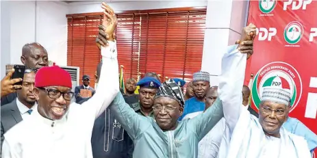  ?? PHOTO: PHILIP OJISUA ?? Delta State Governor, Ifeanyi Okowa ( left) being presented by PDP National Chairman, Iyorchia Ayu ( middle) as running mate to presidenti­al candidate, Atiku Abubakar ( right) at the party’s national secretaria­t in Abuja… yesterday.