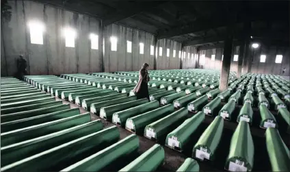  ?? PICTURE: REUTERS ?? A Bosnian Muslim woman examines coffins in Potocari, near Srebrenica, in July 2011.