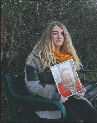  ?? (AP/Alastair Grant) ?? Jo Goodman holds a portrait of her late father Stuart in London. Her father died of covid-19 in April. A couple of months after his death, Goodman co-founded the covid-19 Bereaved Families for Justice group to pressure the government to back a public inquiry into how the pandemic was handled last spring.