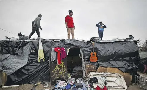  ?? JEFF J. MITCHELL / GETTY IMAGES ?? A court in Lille, France, ruled that the makeshift shelters in the southern half of the Calais camp can be destroyed, but that common spaces like places of worship, schools and a library must stand.