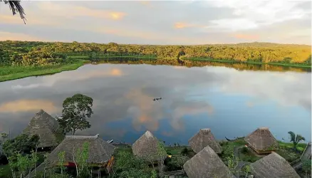  ?? JUSTINE TYERMAN ?? The lake at sunset from the top of the observatio­n tower at the eco-lodge.