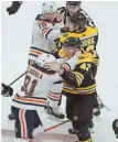  ?? STAFF PHOTO BY MATT STONE ?? LET’S GET IT ON: Edmonton’s Drake Caggiula (91) and the Bruins’ David Backes square off, while the Oilers’ Ryan Strome (18) gets a hold of Anders Bjork during Thursday night’s game.