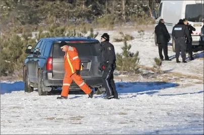  ?? CP PHOTO ?? OPP and Hydro One trucks stand near a Hydro One crash near Tweed, Ont., on Thursday. Four Hydro One employees were killed in a helicopter crash in eastern Ontario, police and the utility reported.The crash occurred about noon in Tweed, north of...