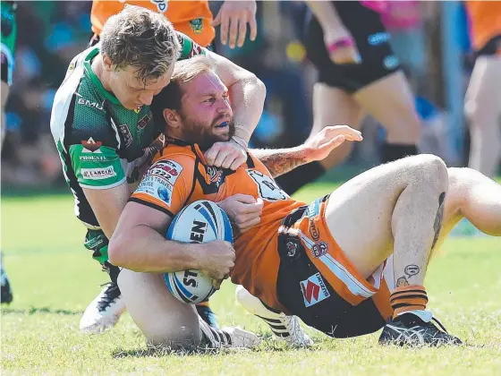 ?? SMASHED: Easts Tigers player Jamie Anderson is tackled by Blackhawks half Kyle Laybutt in last year’s Queensland Cup eliminatio­n final. Picture: ZAK SIMMONDS ??