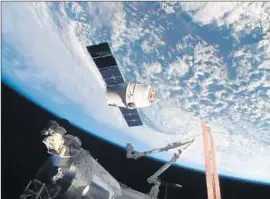  ?? NASA-TV ?? THE SPACEX Dragon-6 resupply capsule holds near the Internatio­nal Space Station as they cross over Asia. The shipment included food and science materials.