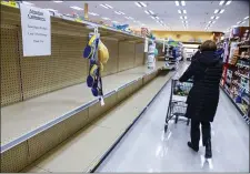  ?? DAN PELLE — THE SPOKESMAN-REVIEW VIA AP ?? Rosauers customers found the shelves empty of toilet paper during senior and at-risk shopping at the grocery store on 29th Avenue, Thursday, March 19, 2020, in Spokane, Wash.