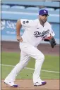  ?? MARK J. TERRILL — AP ?? The Dodgers believe former Angels sluuger Albert Pujols, shown here covering first base during Monday night’s game, can help them, even in a reserve role.