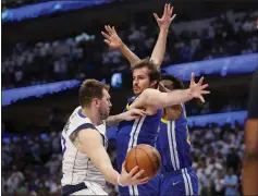  ?? NHAT V. MEYER — BAY AREA NEWS GROUP ?? The Mavericks' Luka Doncic looks to pass around the Warriors' Nemanja Bjelica in the fourth quarter of Game 4of the NBA Western Conference finals Tuesday.