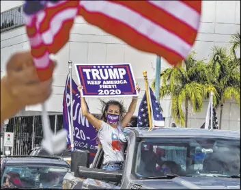  ?? Pedro Portal The Associated Press ?? A pro-Trump caravan drives through the Little Havana neighborho­od of Miami. Florida’s Cuban American voters remain true from the president’s 2016 coalition.