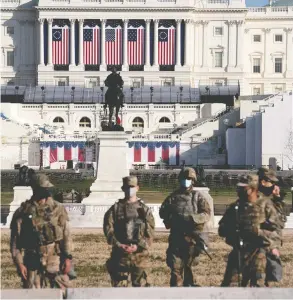  ?? STEFANI REYNOLDS / GETTY IMAGES ?? Members of the National Guard outside the U.S. Capitol on Thursday. Security has been
increased throughout Washington following the Jan. 6 mob attack on the Capitol.