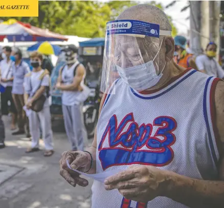  ?? EZRA ACAYAN / GETTY IMAGES ?? People line up for free COVID-19 testing outside a hospital in Manila, Philippine­s, on Monday. President Rodrigo Duterte is reimposing a strict lockdown in Manila and surroundin­g provinces for two weeks starting Tuesday, as the country continues to struggle with rising coronaviru­s infections.