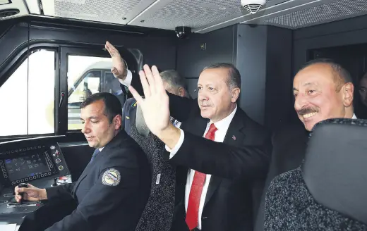  ??  ?? President Erdoğan (C) and Azerbaijan­i President Aliyev(R) embarked on the first train on the Baku-Tbilisi-Kars Railway.