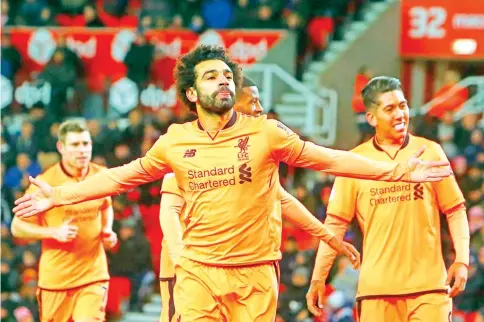  ?? — AFP photo ?? Liverpool’s Egyptian midfielder Mohamed Salah (C) celebrates scoring their second goal during the English Premier League football match between Stoke City and Liverpool at the Bet365 Stadium in Stoke-on-Trent, central England on November 29, 2017.