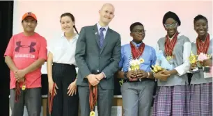  ??  ?? Officials of the World Scholars Cup, Latchin Behlul, Isabel Hahn, Joseph Harr with some students of the Nigerian Tulip Internatio­nal Colleges ( NTIC) at the recently held World Scholars Cup Competitio­n in Abuja.