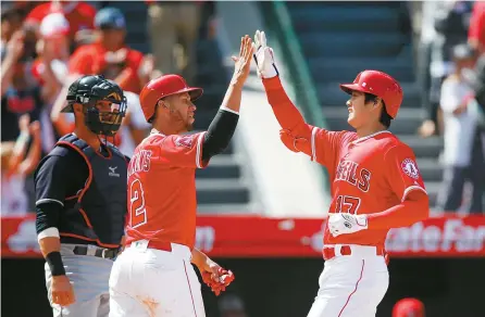  ?? AP-Yonhap ?? Los Angeles Angels’ Shohei Ohtani, right, of Japan, celebrates his two-run home run with Andrelton Simmons as Cleveland Indians catcher Yan Gomes waits during the fifth inning of a baseball game in Anaheim, Calif., Wednesday.