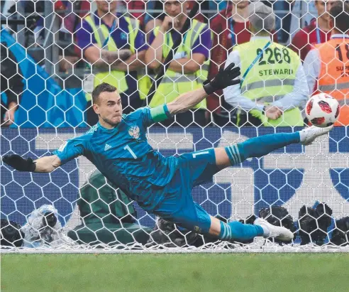  ?? Picture: AFP ?? SHOT STOPPER: Russia's goalkeeper Igor Akinfeev uses an outstretch­ed leg to save Spain’s Iago Aspas’s spot kick and send the host nation through to the quarter-finals of the World Cup.