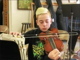  ?? ZACH SRNIS — THE MORNING JOURNAL ?? Jaxon Cogar, a 13-year-old seventh-grader, practices the viola.
