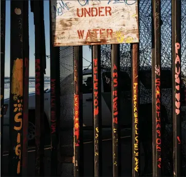  ?? THE ASSOCIATED PRESS ?? A Border Patrol officer inside his vehicle guards the border fence at the U.S. side in San Diego last week.