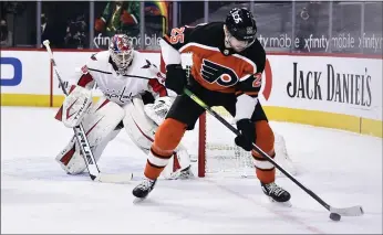  ?? DERIK HAMILTON - THE ASSOCIATED PRESS ?? Capitals goalie Ilya Samsonov, left, watches the Flyers’ James van Riemsdyk play the puck during the third period Saturday. A third-period comeback was too little, too late in a 5-4Flyers loss.