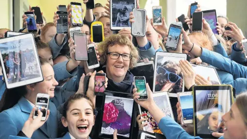  ?? PHOTO: STEPHEN JAQUIERY ?? Wraparound care . . . St Hilda’s Collegiate principal Jackie Barron amid a sea of cellphones and tablets that will be controlled by the school next year.