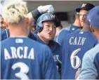  ?? JOHNSON / USA TODAY SPORTS JORDAN ?? Milwaukee Brewers designated hitter Ji-Man Choi reacts with teammates after he socks a solo home run during the second inning Friday night.