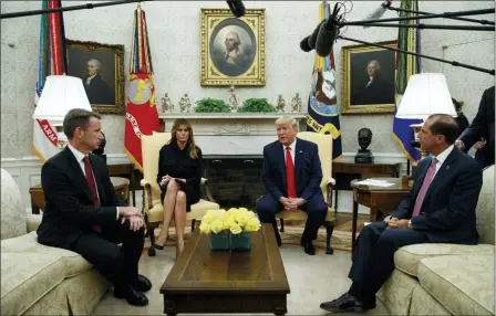  ?? EVAN VUCCI — THE ASSOCIATED PRESS ?? President Donald Trump talks about a plan to ban most flavored e-cigarettes, in the Oval Office of the White House, Wednesday in Washington. From left, acting FDA Commission­er Ned Sharpless, first lady Melania Trump, Trump, and Secretary of Health and Human Services Alex Azar.