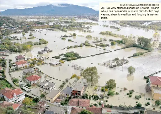  ?? GENT SHKULLAKU/AGENCE FRANCE-PRESSE ?? AERIAL view of flooded houses in Shkodra, Albania which has been under intensive rains for two days causing rivers to overflow and flooding its western plain.