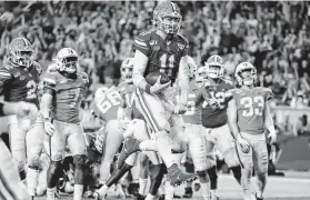  ?? Lynne Sladky / Associated Press ?? Florida quarterbac­k Kyle Trask (11) scores a touchdown against Virginia during the second half of the Orange Bowl.