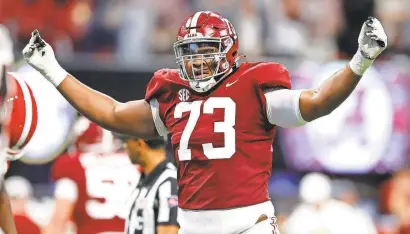  ?? TODD KIRKLAND/GETTY IMAGES ?? The 6-7, 337-pound frame alone makes Evan Neal stand out, but his appeal isn’t just his physique. He packs a punch as a run blocker and flexible (and even fast).